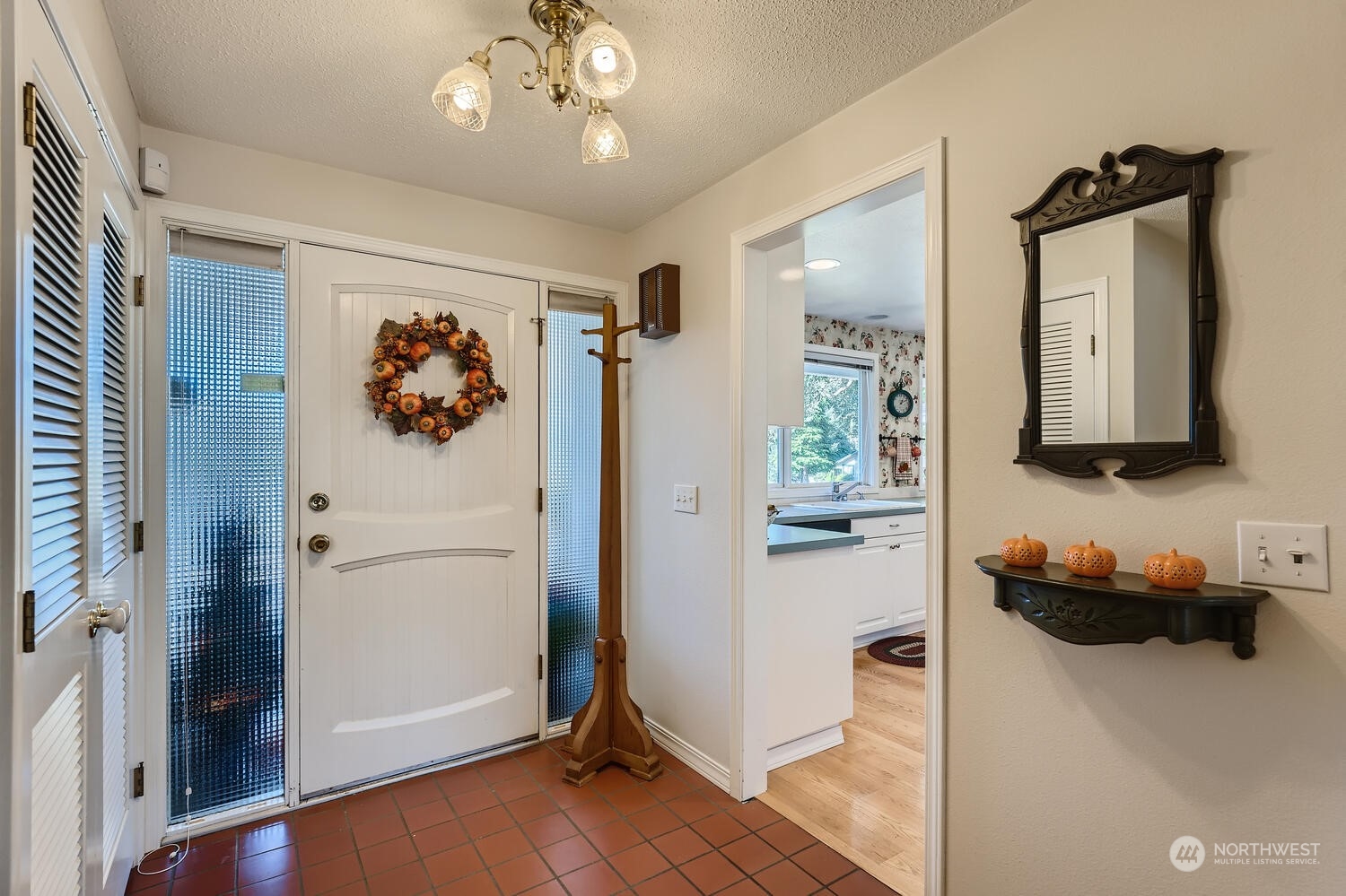 12823 Spanaway Loop Road South Tacoma, WA 98444 - Photo 4 of 38 a hallway with a refrigerator and a wooden floor