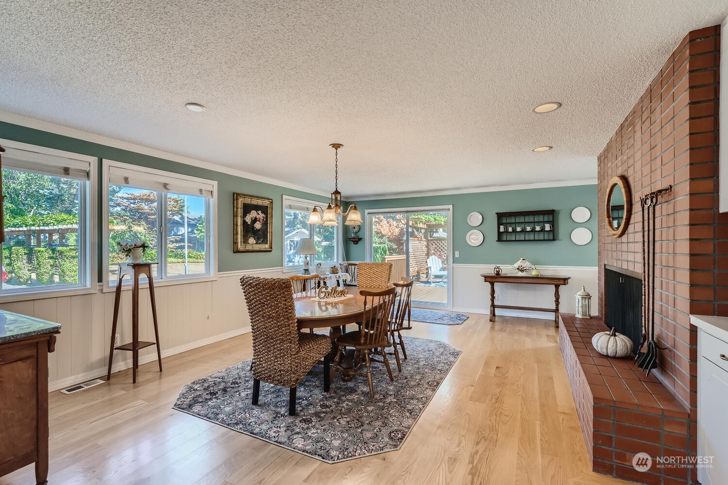 12823 Spanaway Loop Road South Tacoma, WA 98444 - Photo 9 of 38 a dining room with furniture a chandelier and wooden floor