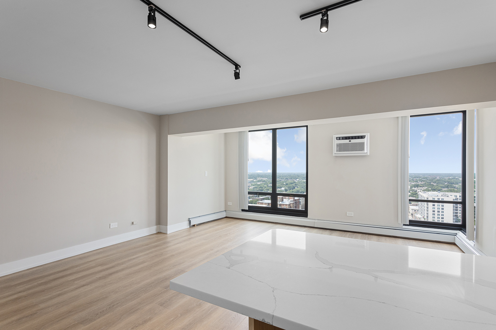 6166 North Sheridan Road, Unit 22B Chicago, IL 60660 - Photo 3 of 18 an empty room with wooden floor and windows