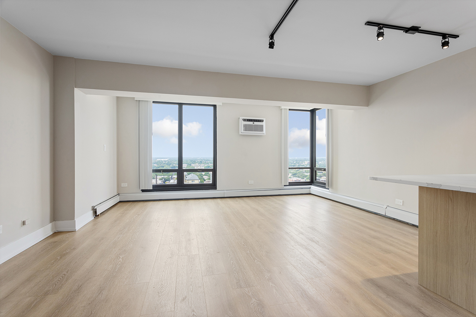 6166 North Sheridan Road, Unit 22B Chicago, IL 60660 - Photo 4 of 18 an empty room with wooden floor and windows