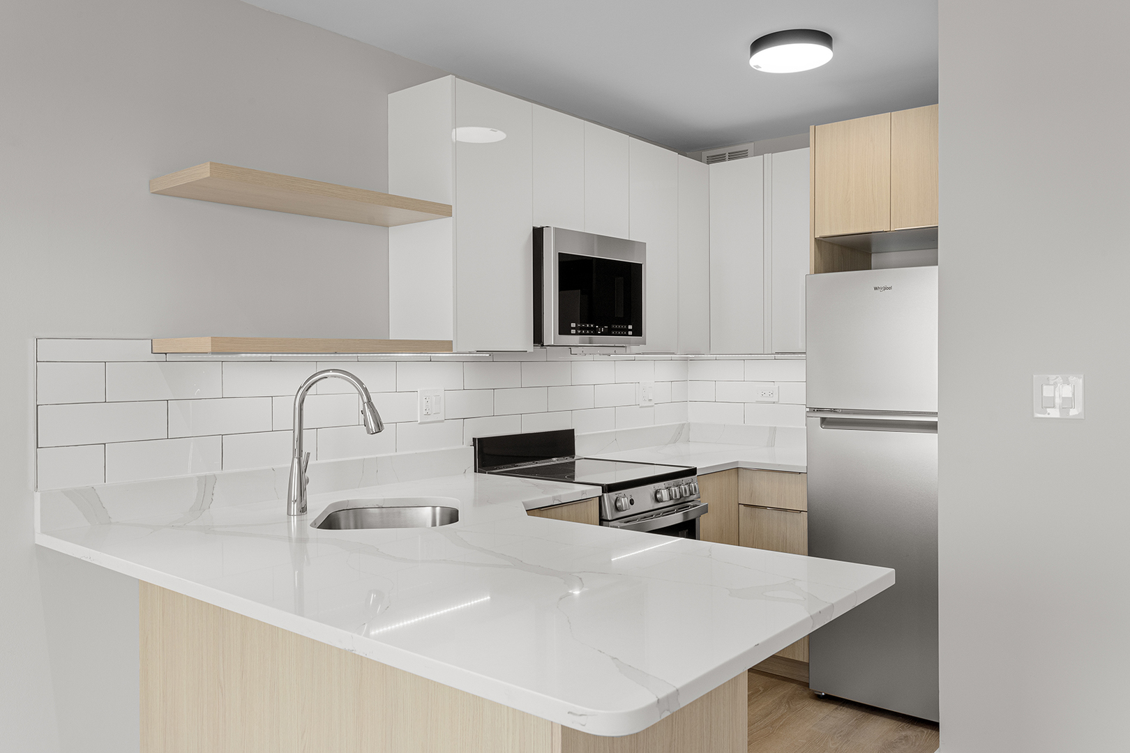 6166 North Sheridan Road, Unit 22B Chicago, IL 60660 - Photo 6 of 18 a kitchen with a sink a refrigerator and cabinets