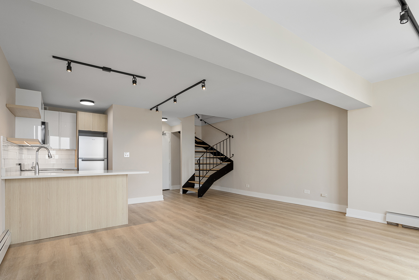 6166 North Sheridan Road, Unit 22B Chicago, IL 60660 - Photo 7 of 18 a view of a kitchen with wooden floor and a sink
