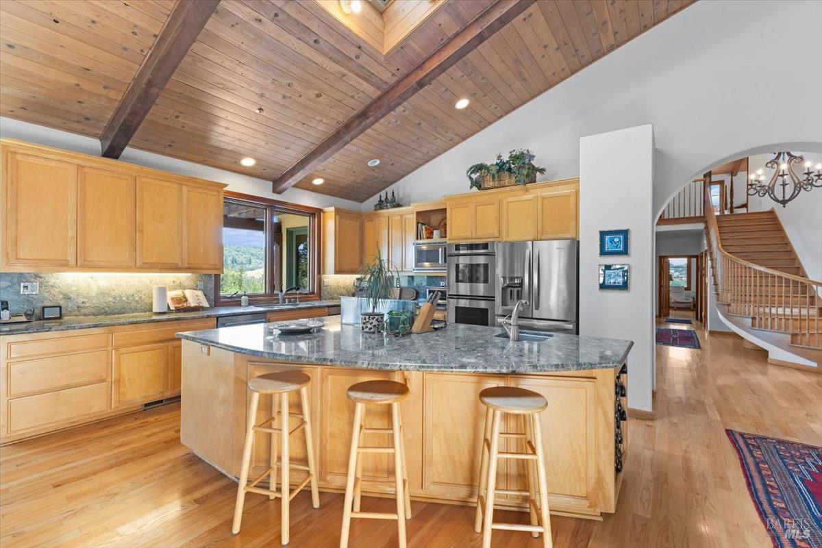 13404 Flora Ranch Road Healdsburg, CA 95448 - Photo 29 of 66 a large kitchen with granite countertop lots of counter space and window