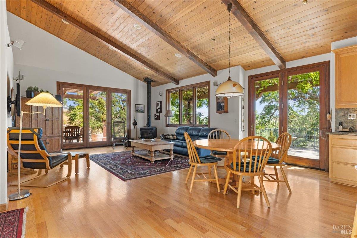 13404 Flora Ranch Road Healdsburg, CA 95448 - Photo 32 of 66 a view of a dining room with furniture window and wooden floor