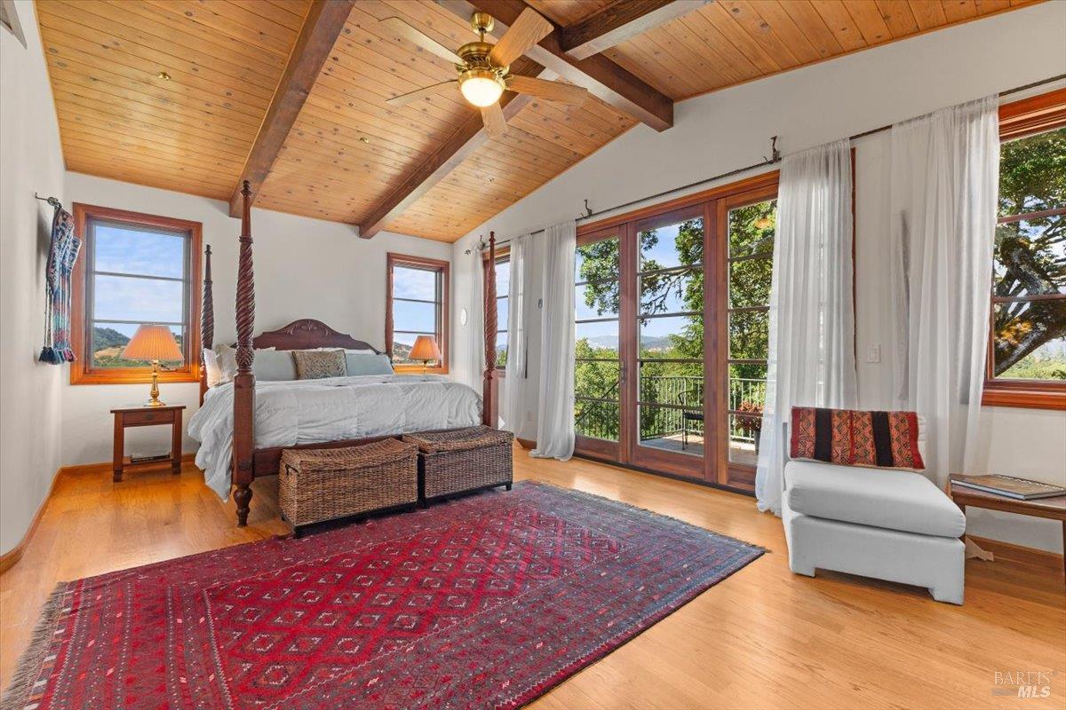 13404 Flora Ranch Road Healdsburg, CA 95448 - Photo 33 of 66 a bedroom with a bed and wooden floor