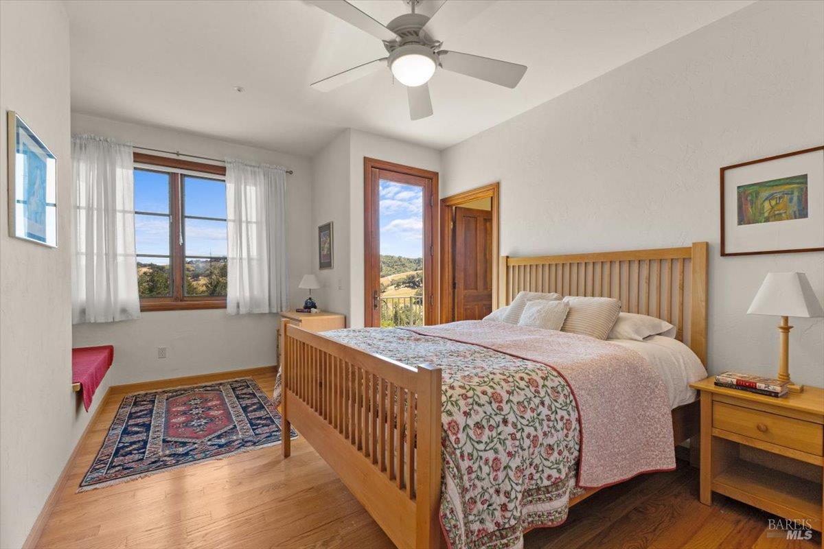 13404 Flora Ranch Road Healdsburg, CA 95448 - Photo 38 of 66 a bedroom with a bed and a chandelier