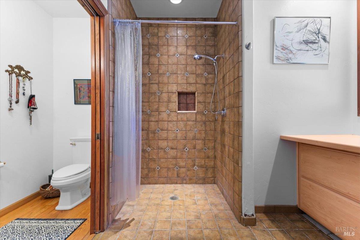13404 Flora Ranch Road Healdsburg, CA 95448 - Photo 43 of 66 a bathroom with a shower and a toilet