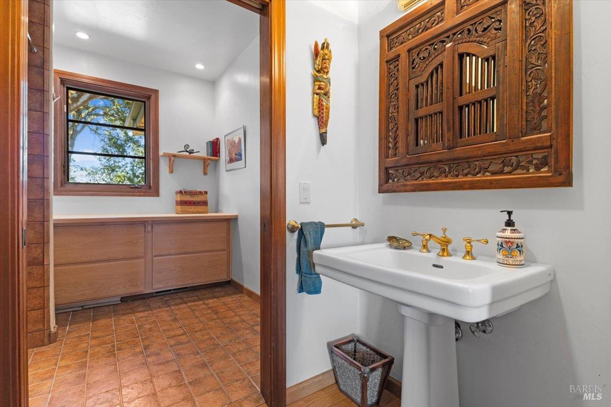 13404 Flora Ranch Road Healdsburg, CA 95448 - Photo 44 of 66 a bathroom with a sink and a mirror
