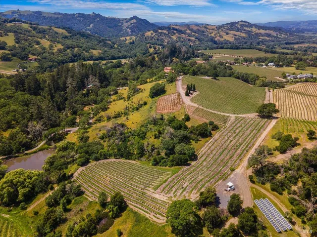 an aerial view of a house with a yard