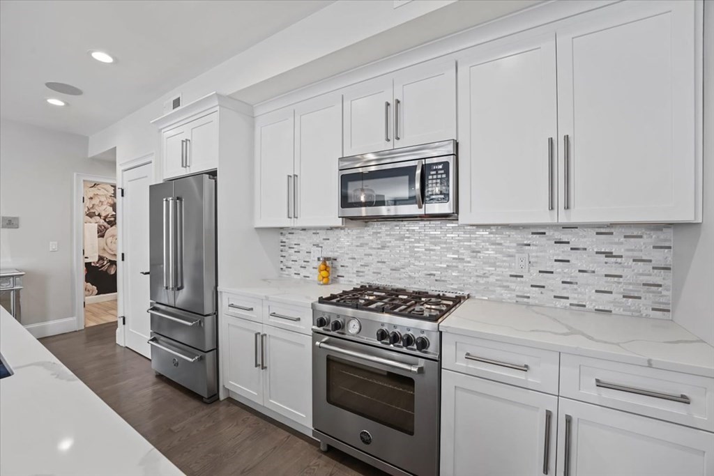 2-4 Elm Street, Unit 2B Boston, MA 02122 - Photo 12 of 27 a kitchen with cabinets stainless steel appliances and a counter space