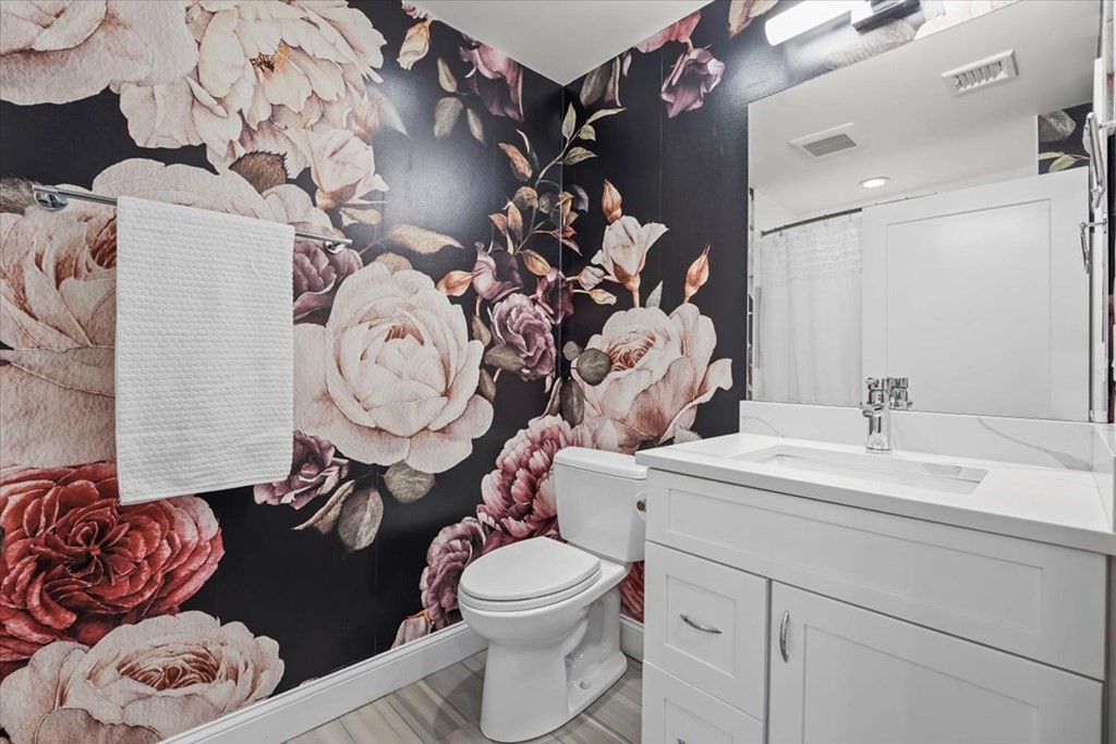 2-4 Elm Street, Unit 2B Boston, MA 02122 - Photo 14 of 27 a bathroom with a toilet sink and mirror
