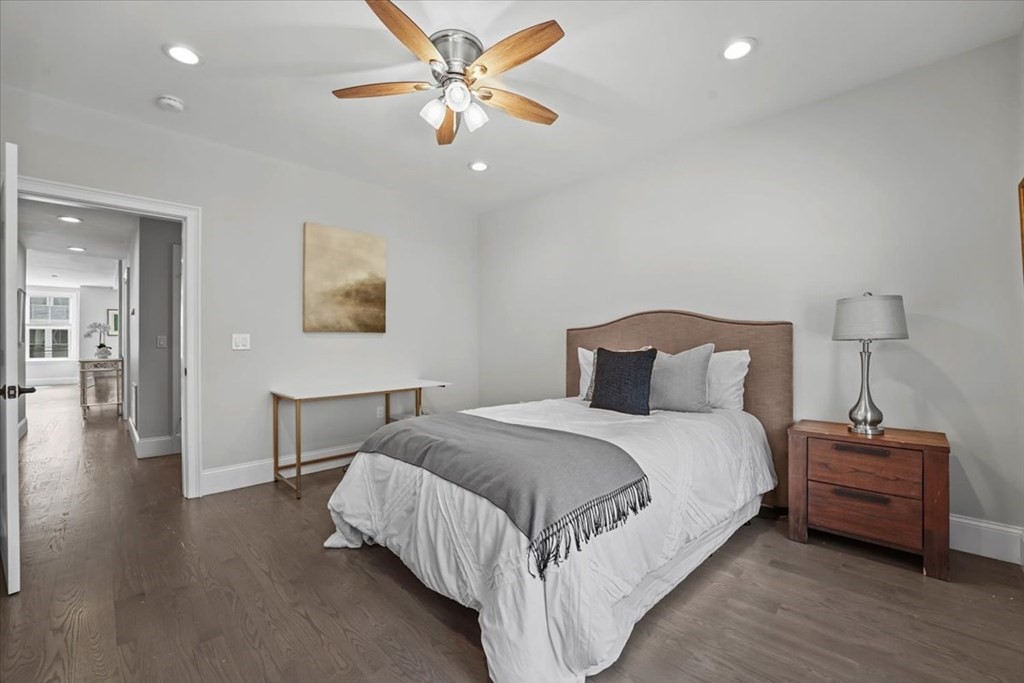 2-4 Elm Street, Unit 2B Boston, MA 02122 - Photo 16 of 27 a bedroom with a bed and a chandelier