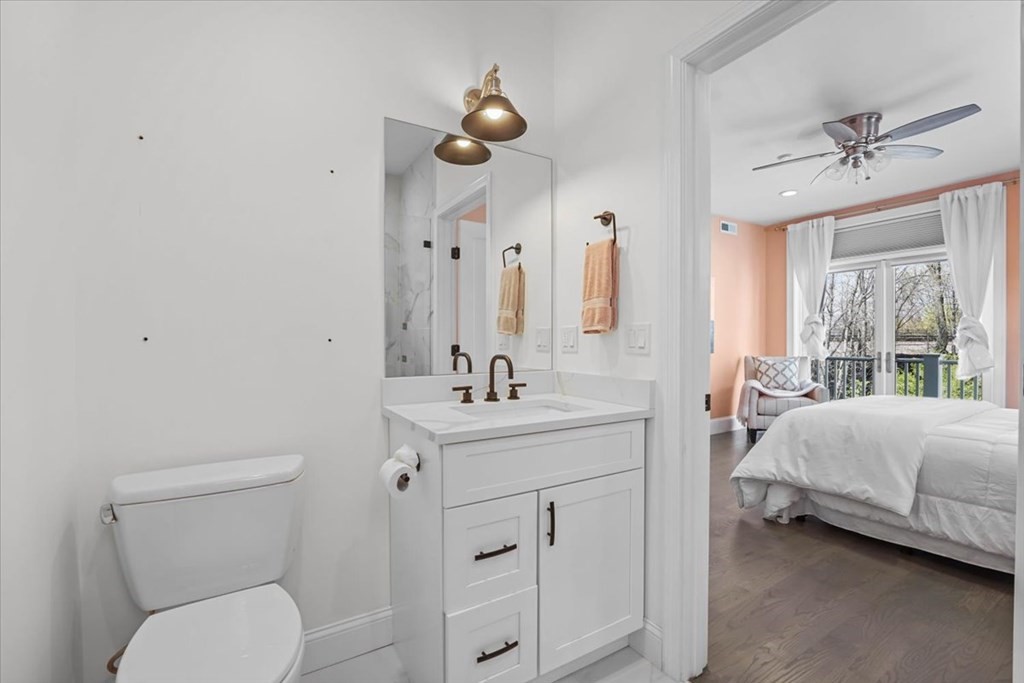 2-4 Elm Street, Unit 2B Boston, MA 02122 - Photo 17 of 27 a bathroom with a toilet a sink and mirror