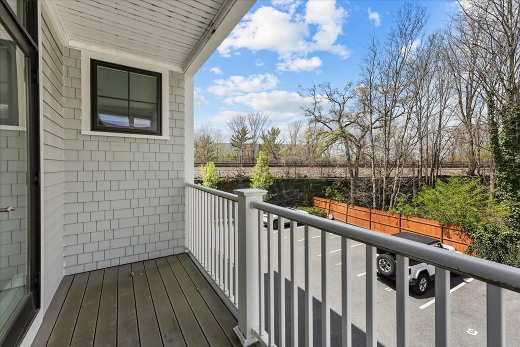 2-4 Elm Street, Unit 2B Boston, MA 02122 - Photo 22 of 27 a view of a balcony with wooden floor and fence