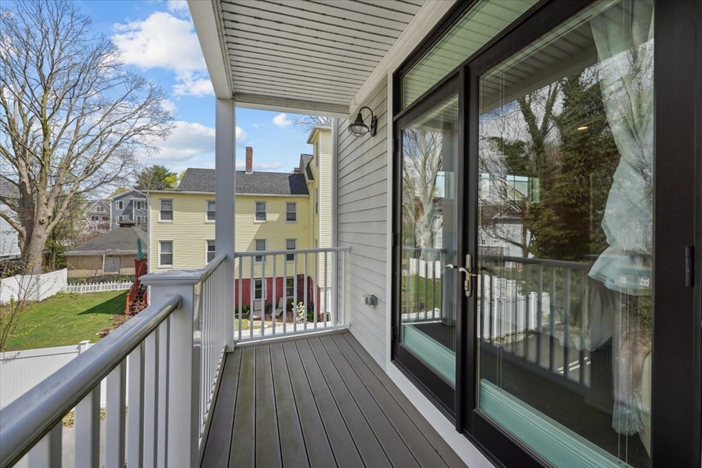 2-4 Elm Street, Unit 2B Boston, MA 02122 - Photo 23 of 27 a view of a house with a wooden deck