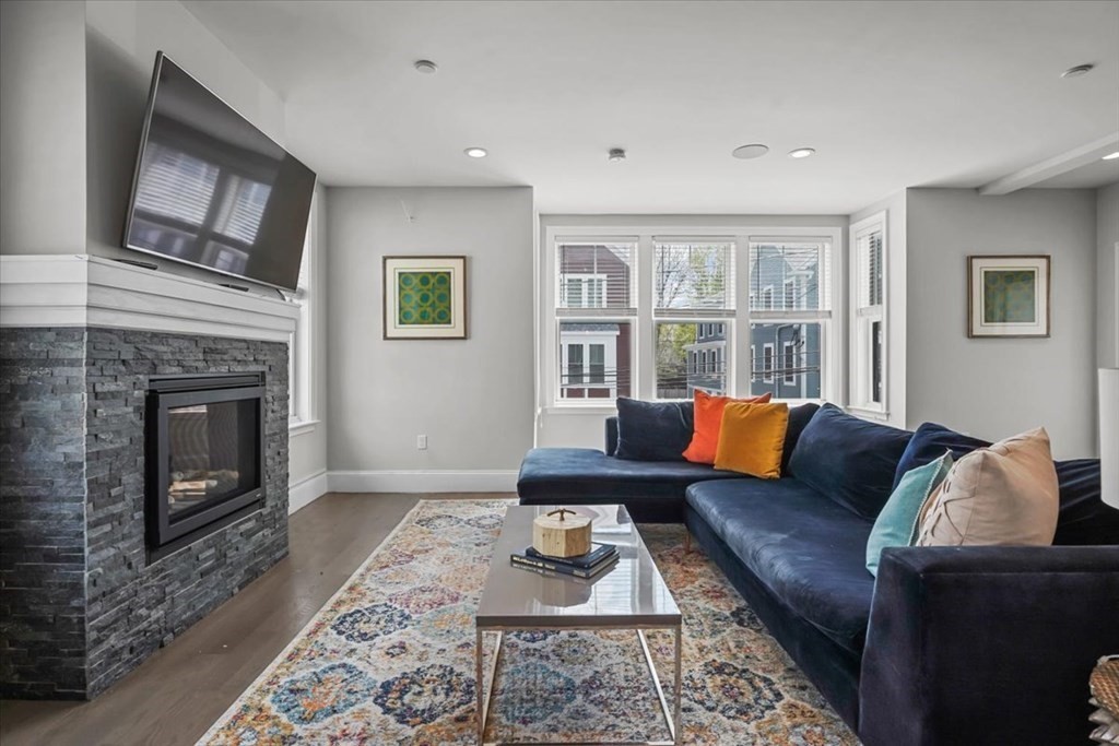 2-4 Elm Street, Unit 2B Boston, MA 02122 - Photo 5 of 27 a living room with furniture and a fireplace