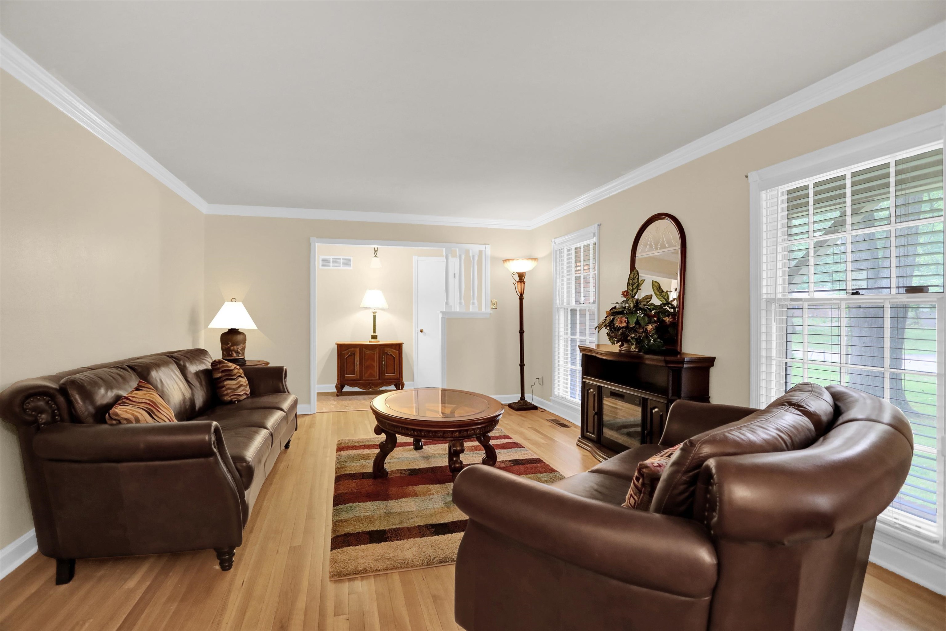 1277 Old Hickory Road Memphis, TN 38116 - Photo 12 of 29 Living area with crown molding, baseboards, light wood-type flooring, and visible vents