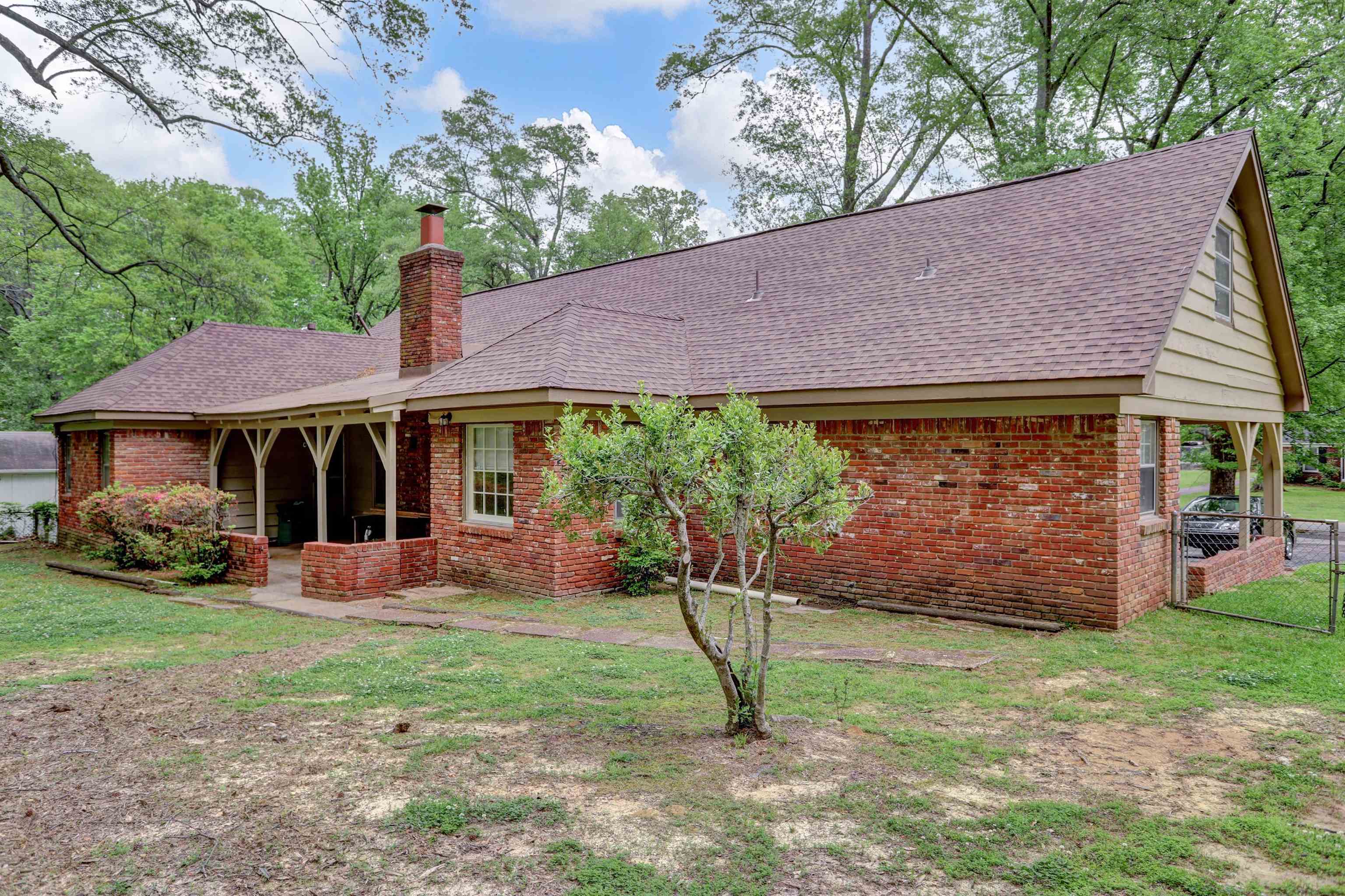 1277 Old Hickory Road Memphis, TN 38116 - Photo 28 of 29 Back of property with brick siding, fence, a chimney, and a shingled roof