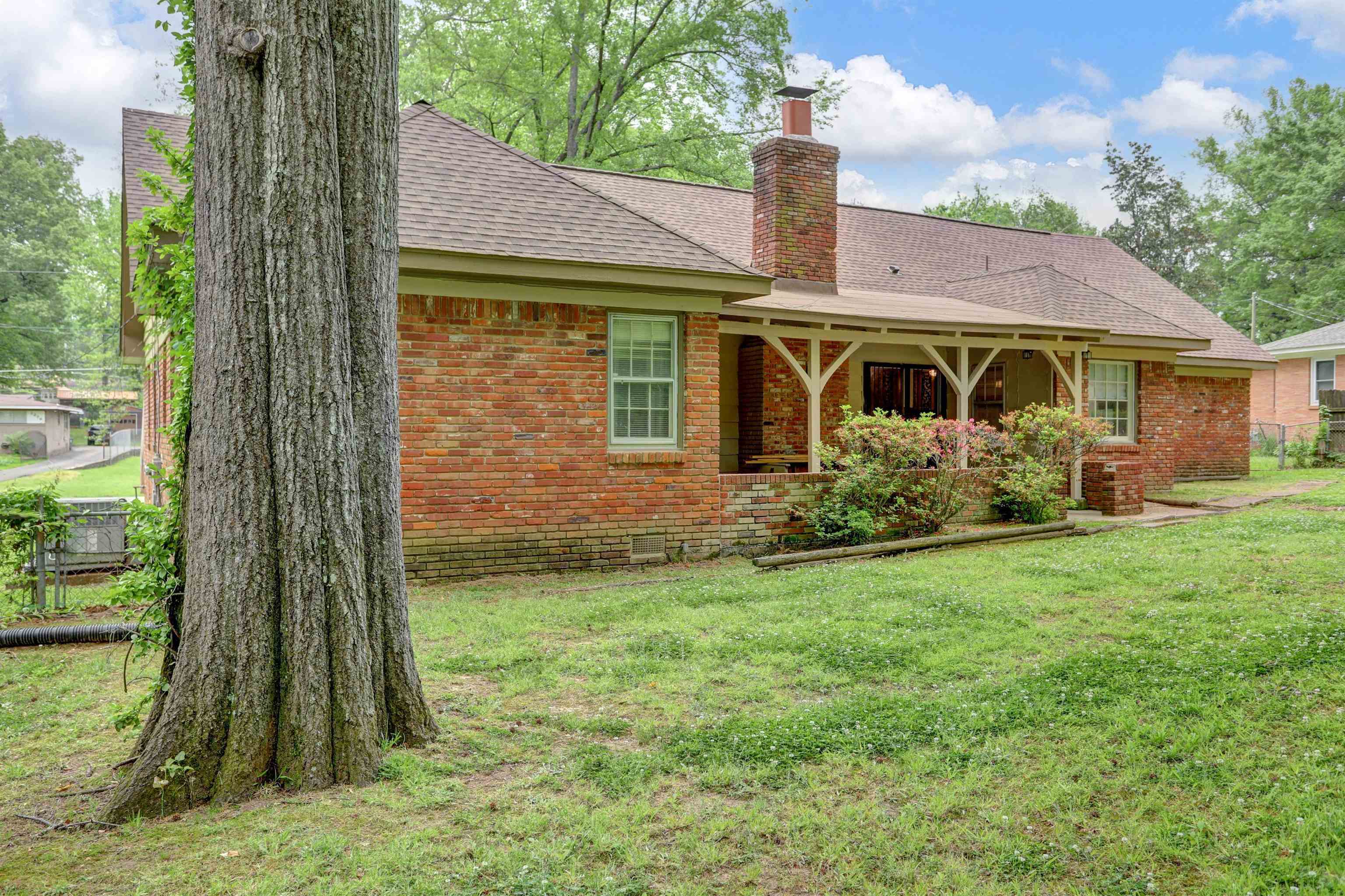 1277 Old Hickory Road Memphis, TN 38116 - Photo 29 of 29 Back of property featuring roof with shingles, a chimney, brick siding, crawl space, and a lawn