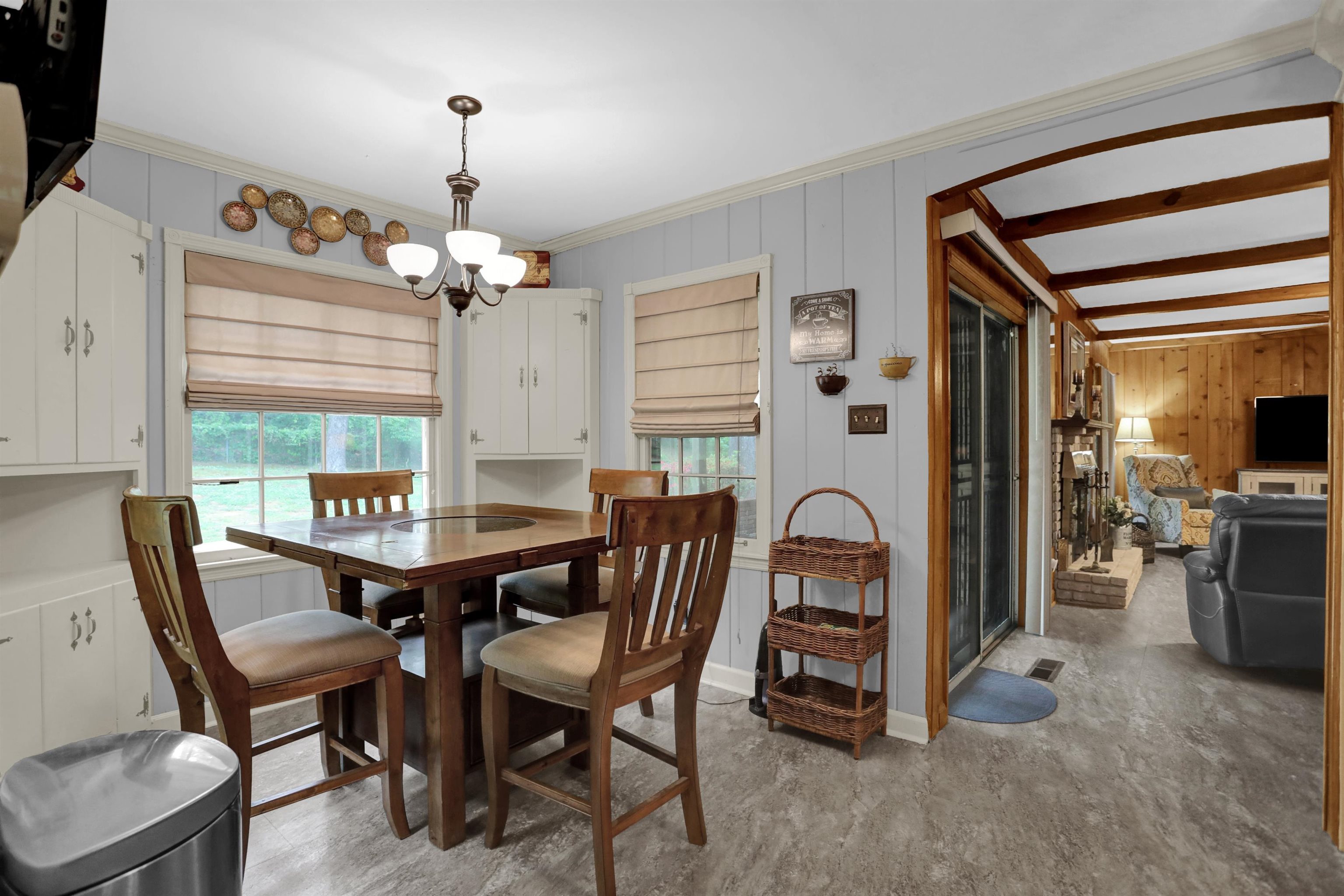 1277 Old Hickory Road Memphis, TN 38116 - Photo 7 of 29 Dining space featuring crown molding, wooden walls, and a chandelier