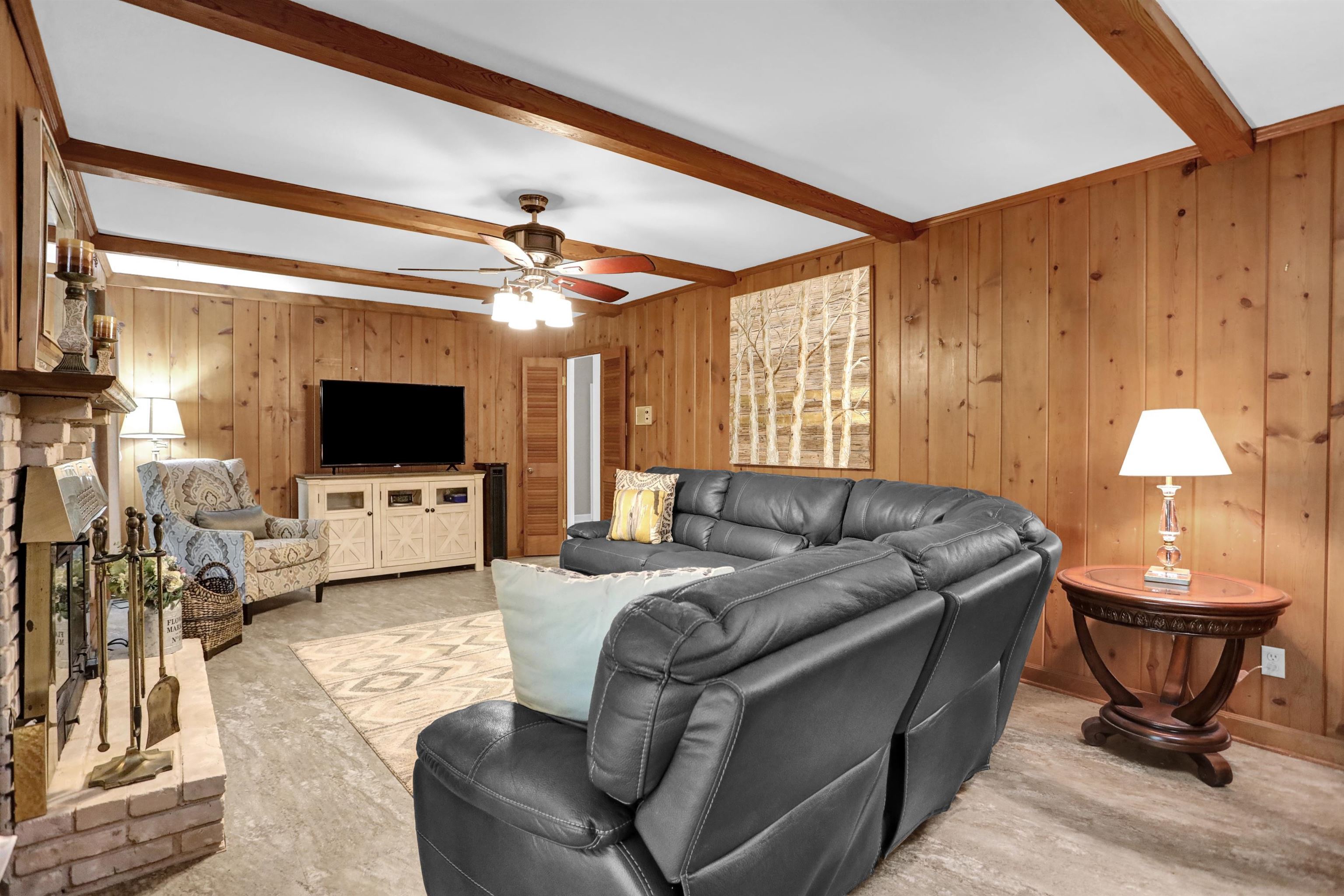 1277 Old Hickory Road Memphis, TN 38116 - Photo 9 of 29 Living room featuring wood walls, ceiling fan, and beamed ceiling