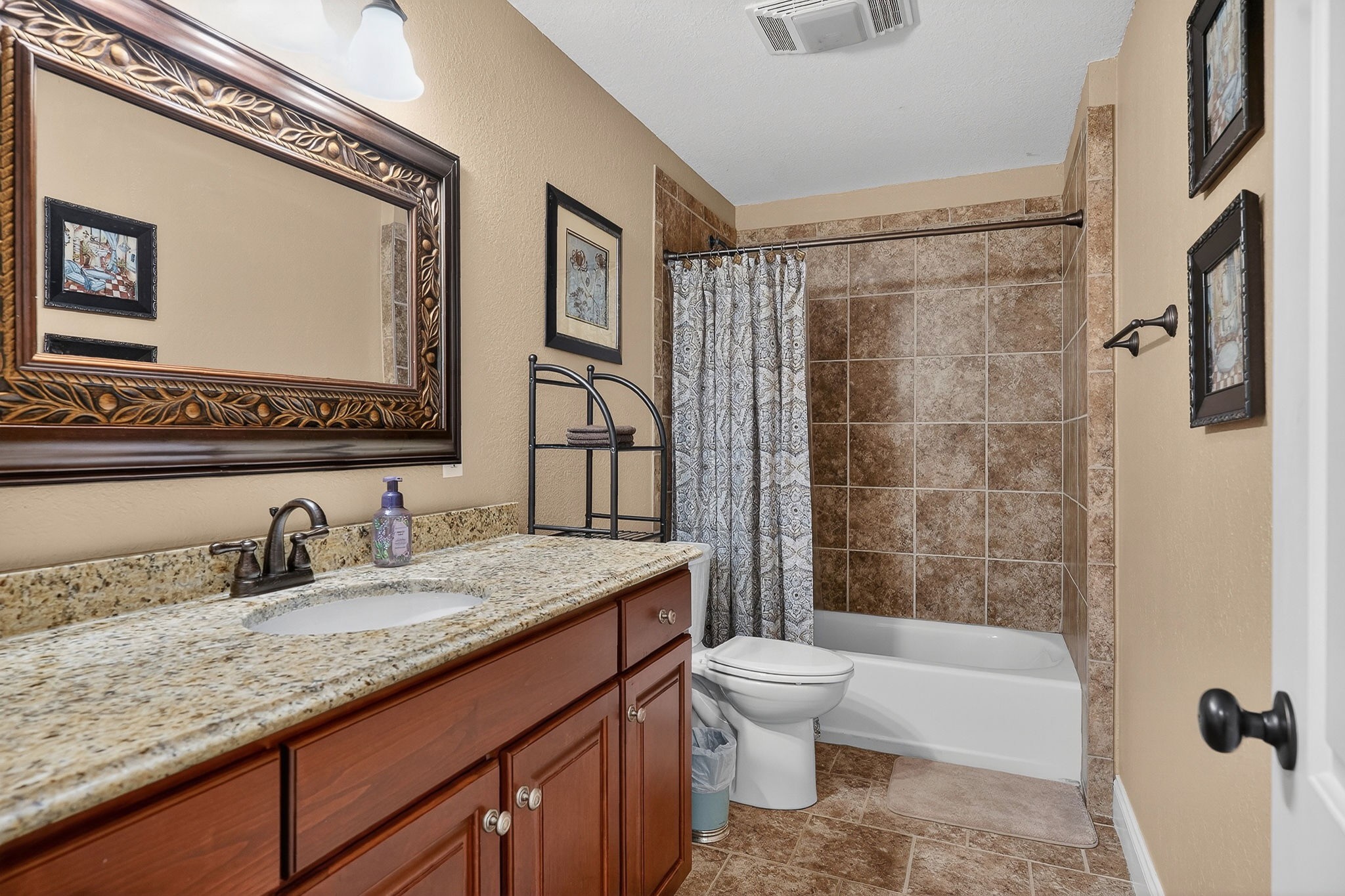 933 John Henry Lewis Road Dunlap, TN 37327 - Photo 52 of 100 a bathroom with a granite countertop sink a toilet a mirror a bathtub and shower