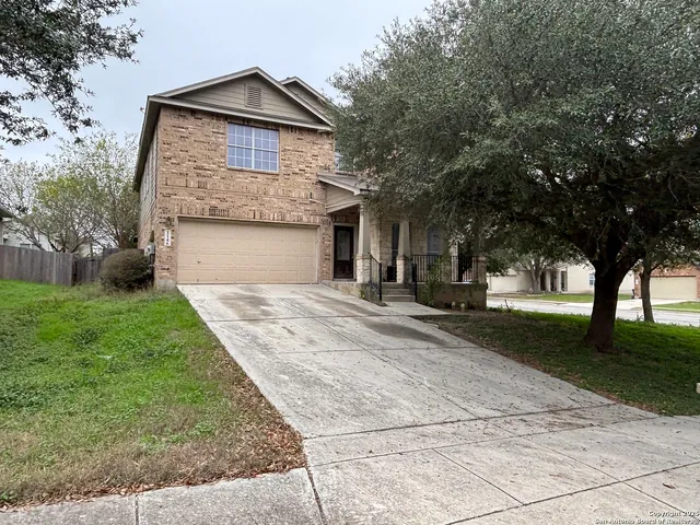 a view of a house with yard and tree s