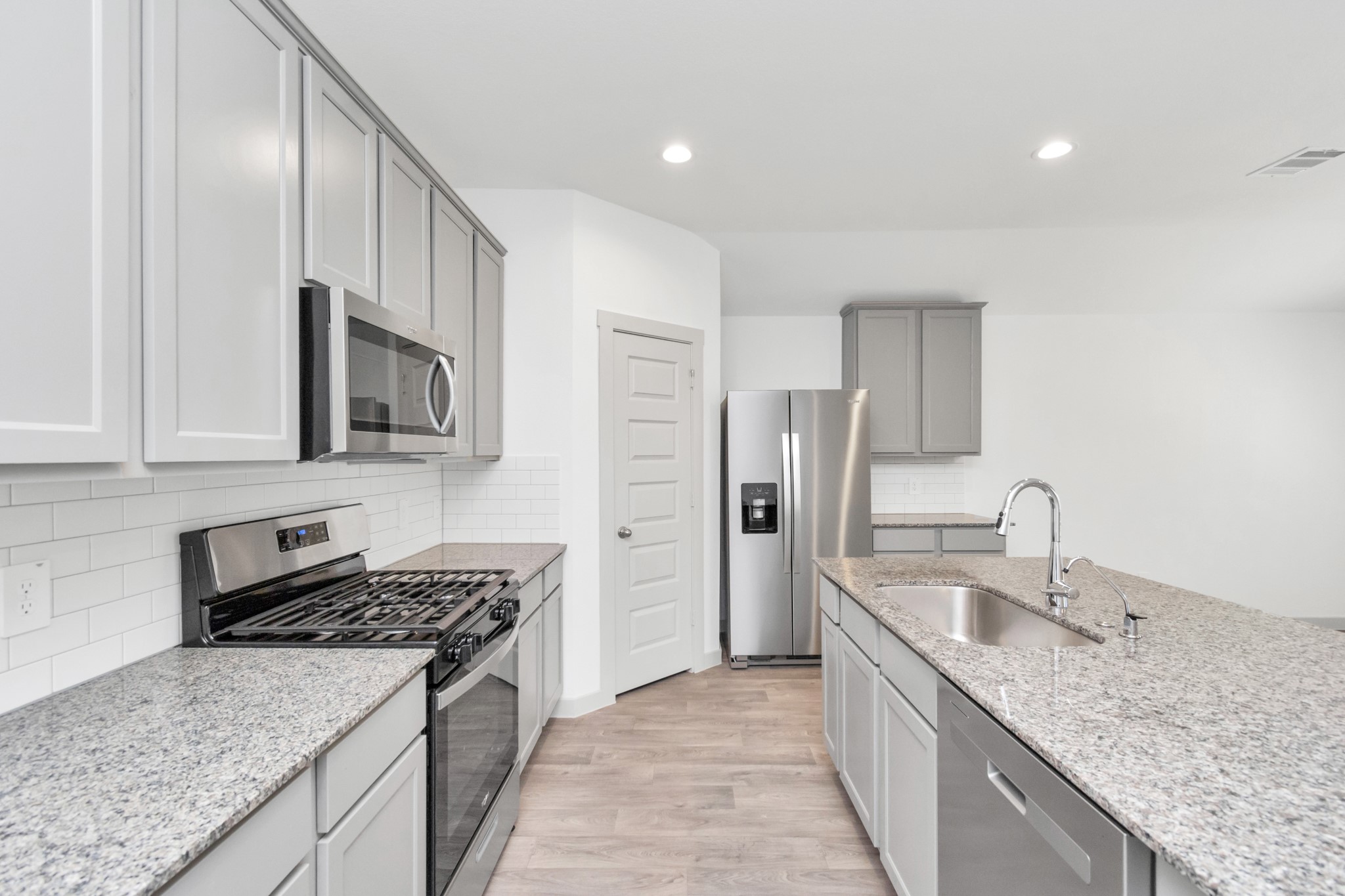 10626 Watershed Drive Rosharon, TX 77583 - Photo 24 of 42 a kitchen with stainless steel appliances granite countertop a sink stove and refrigerator