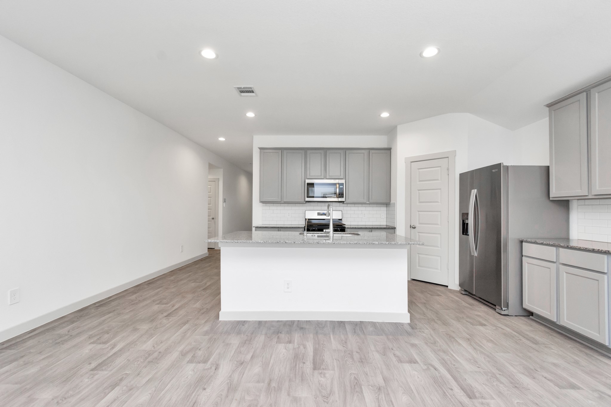 10626 Watershed Drive Rosharon, TX 77583 - Photo 26 of 42 a kitchen with stainless steel appliances a refrigerator sink and cabinets