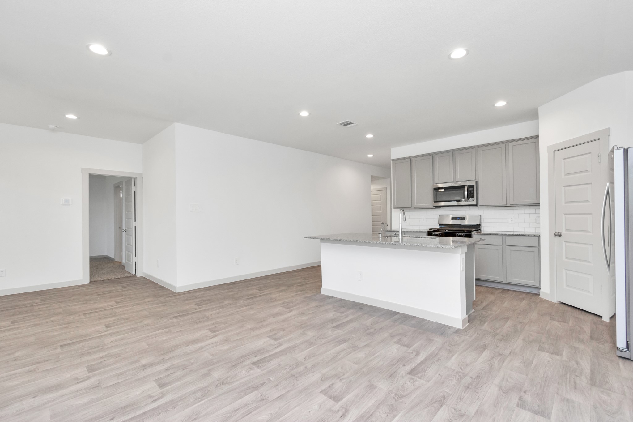 10626 Watershed Drive Rosharon, TX 77583 - Photo 27 of 42 a kitchen with a refrigerator and white cabinets