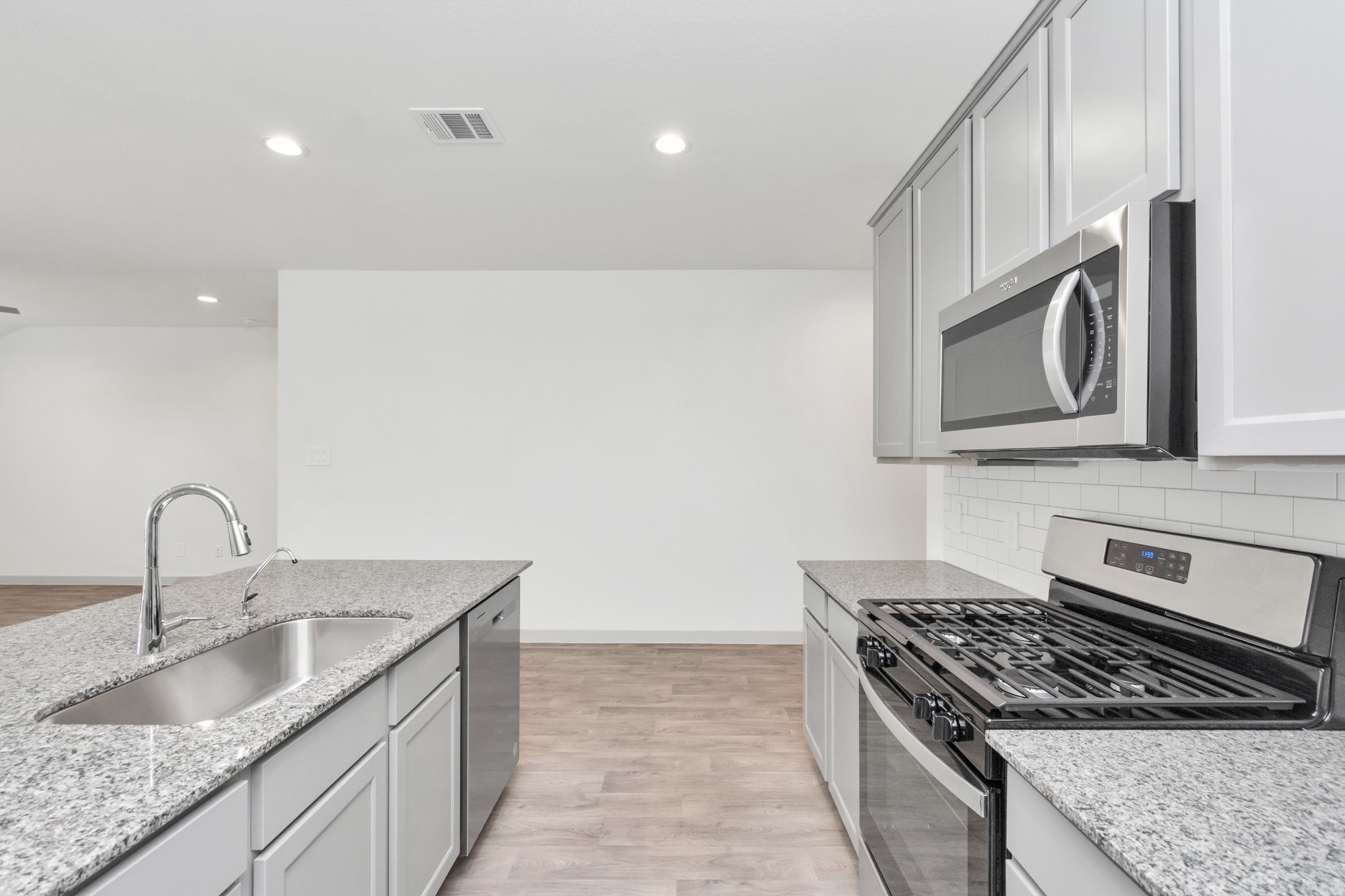 10626 Watershed Drive Rosharon, TX 77583 - Photo 28 of 42 a kitchen with granite countertop a sink stainless steel appliances and cabinets