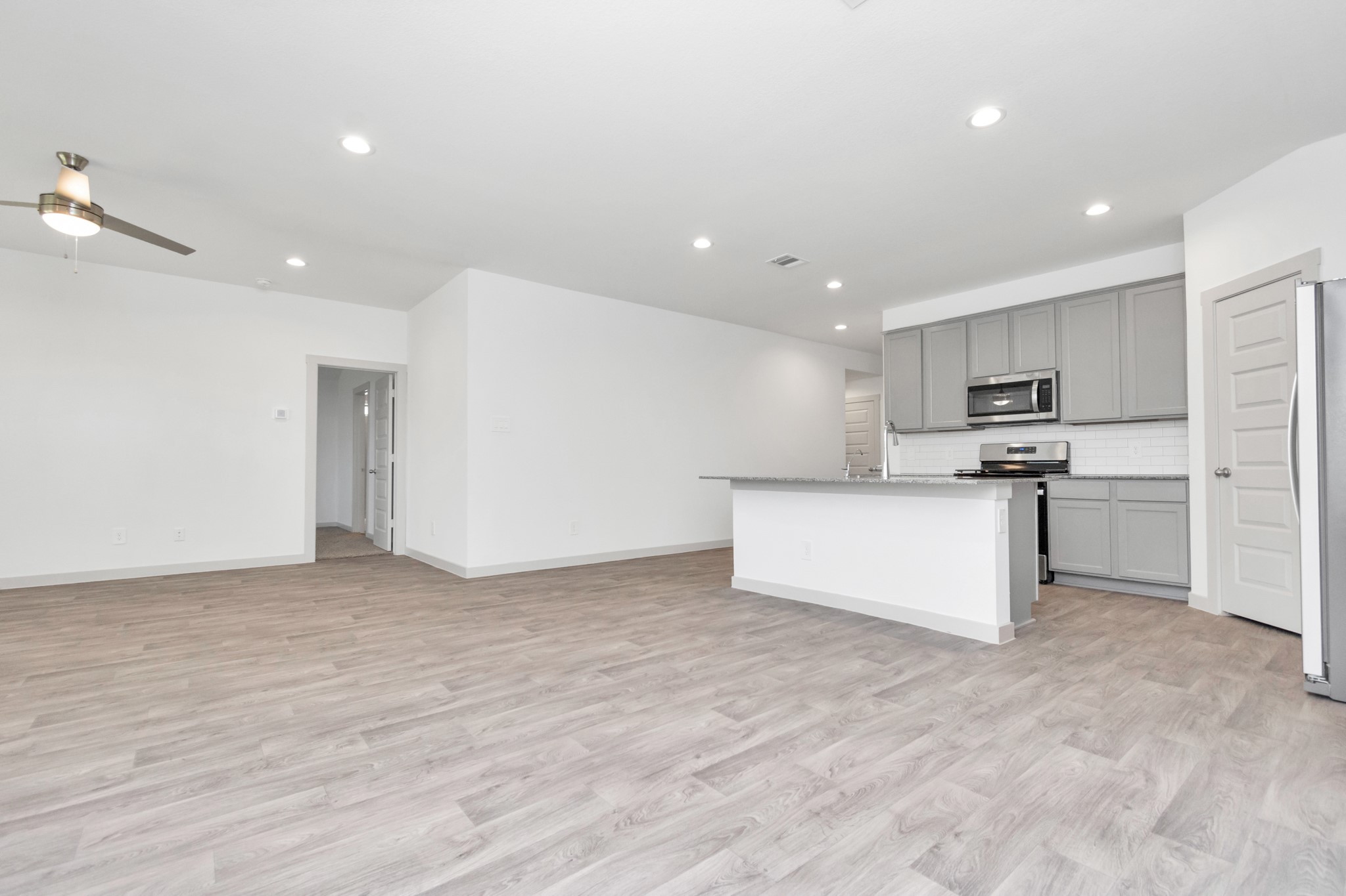 10626 Watershed Drive Rosharon, TX 77583 - Photo 30 of 42 a view of kitchen with kitchen island a sink wooden floor and stainless steel appliances