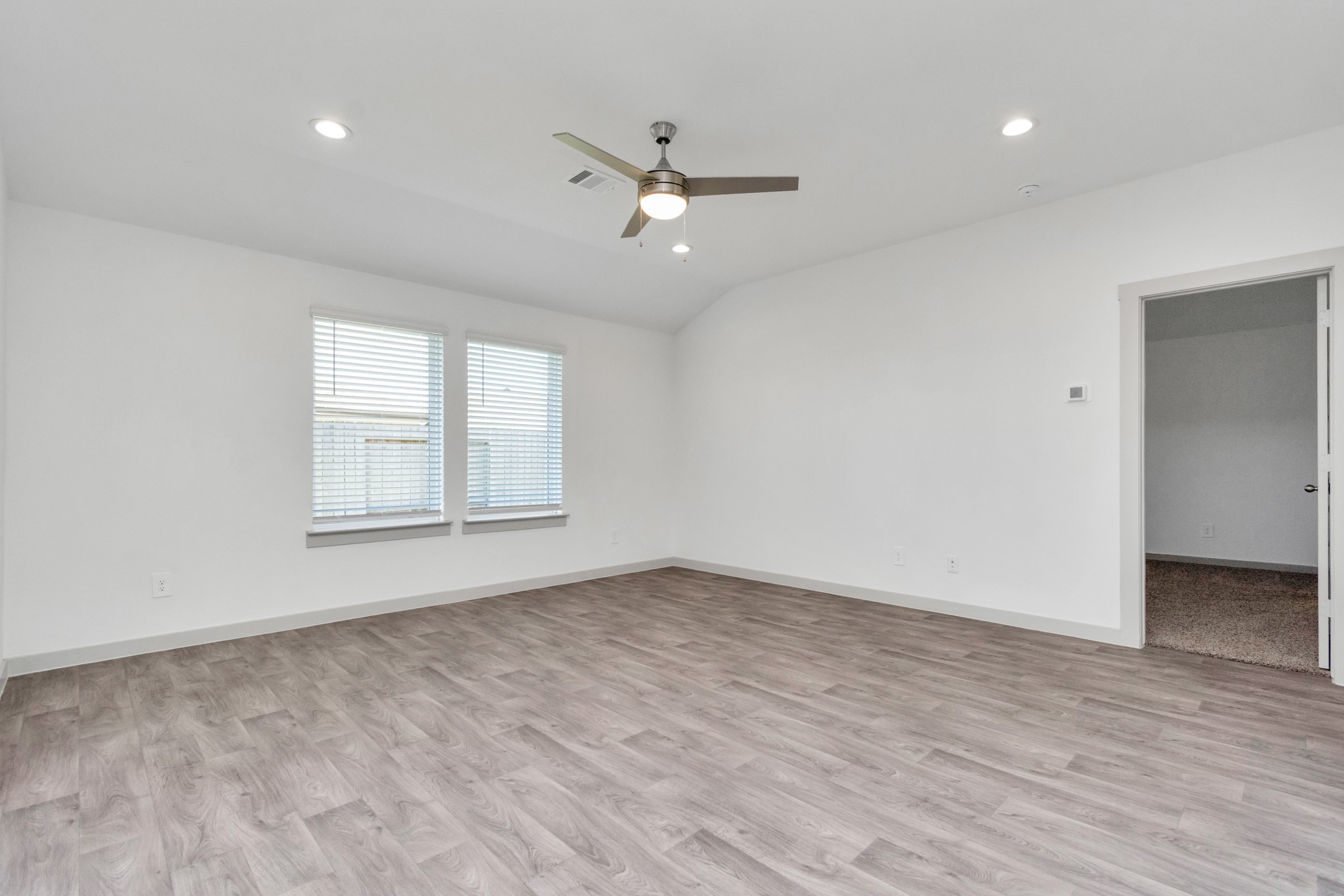 10626 Watershed Drive Rosharon, TX 77583 - Photo 31 of 42 an empty room with wooden floor ceiling fan and windows