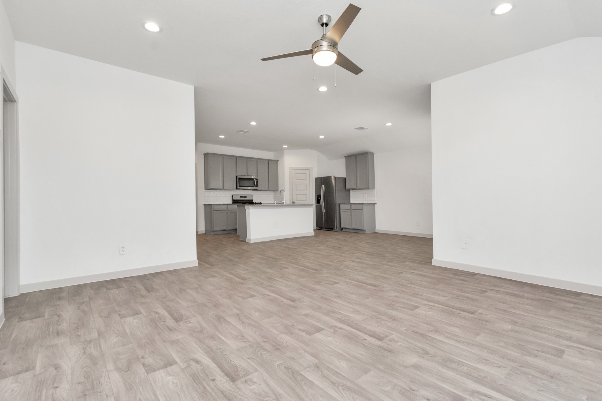 10626 Watershed Drive Rosharon, TX 77583 - Photo 33 of 42 a view of a kitchen with a sink and a refrigerator