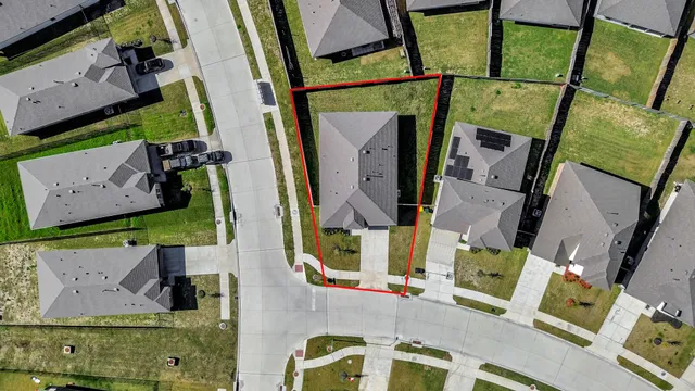 an aerial view of residential houses with outdoor space