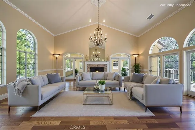 a living room with furniture chandelier and a large window