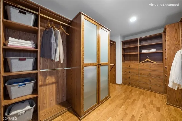 a view of a hallway with wooden floor and closet