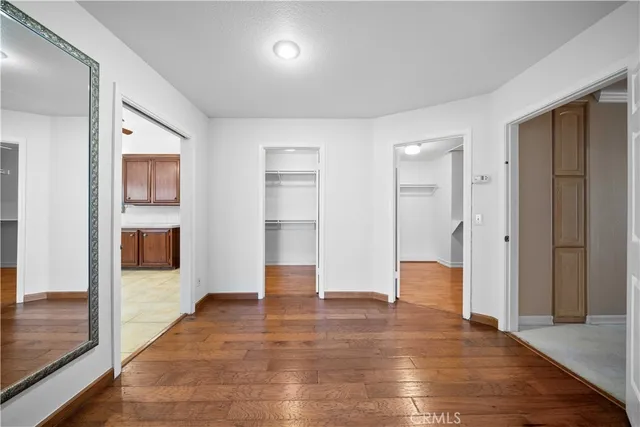 a bedroom with a large bed and a potted plant