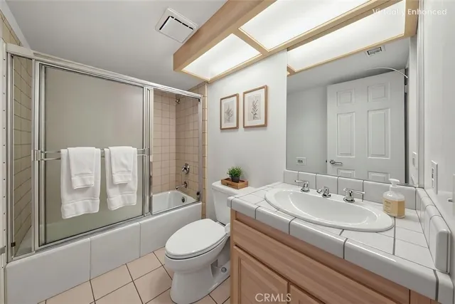 a bedroom with a bed and a potted plant