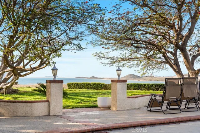 a front view of a house with swimming pool and garden