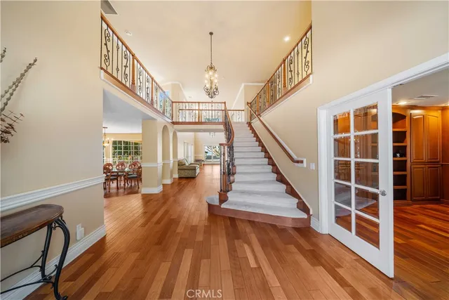 a view of entryway and hall with wooden floor