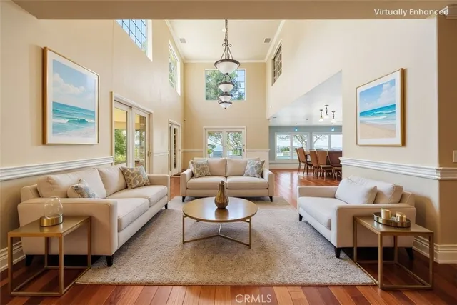 a living room with furniture wooden floor and a table