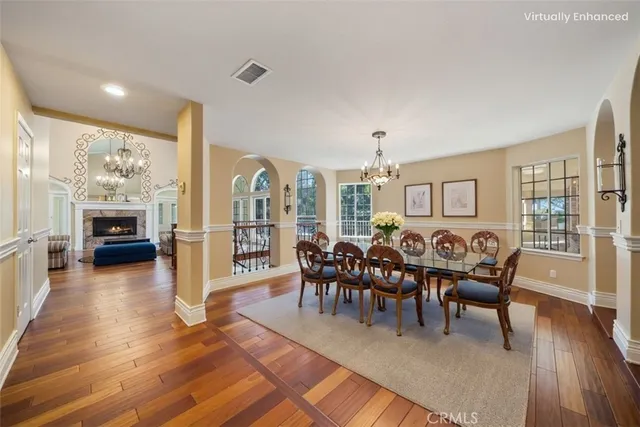a living room with furniture a wooden floor and next to a window