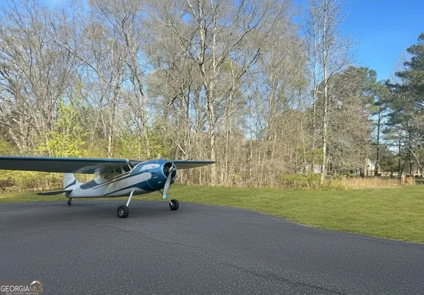 a sign broad in front of the red brick house