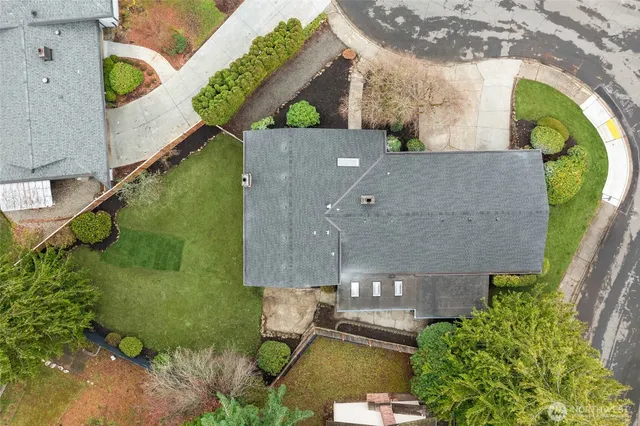 an aerial view of a house with a yard