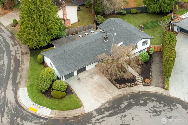 an aerial view of a house with yard