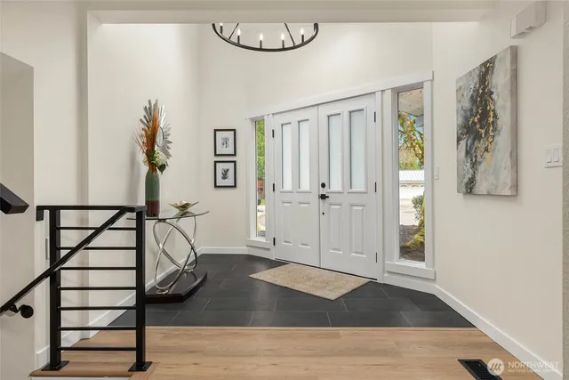 a view of a livingroom with wooden floor and furniture