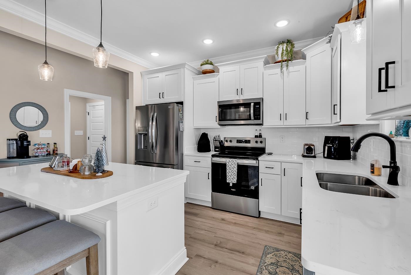 384 William Nobles Road Aynor, SC 29511 - Photo 12 of 38 Kitchen featuring pendant lighting, stainless steel appliances, white cabinets, a breakfast bar area, and light wood-style floors
