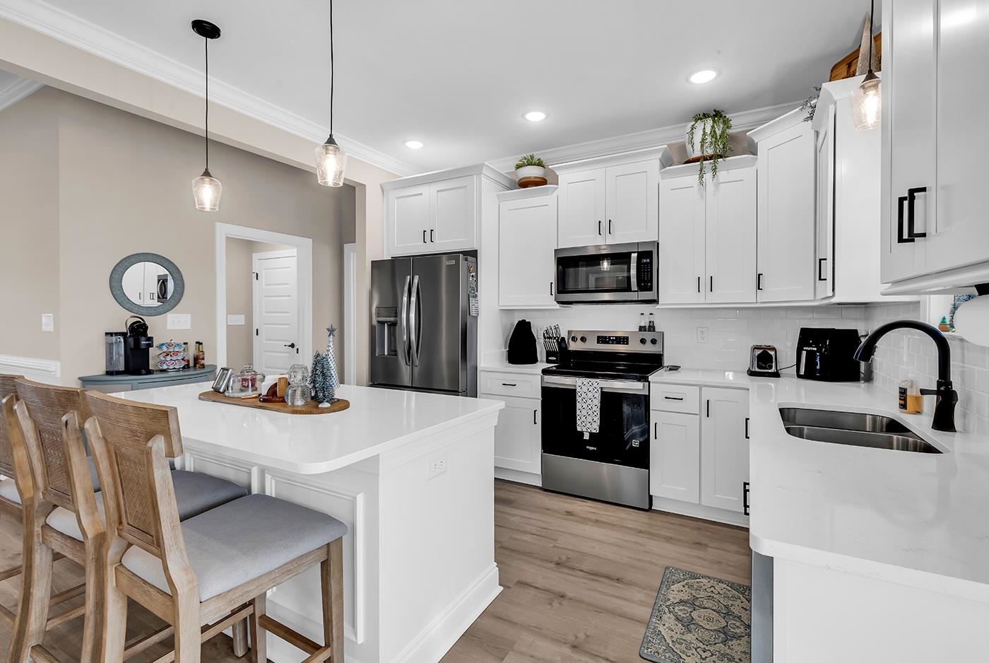384 William Nobles Road Aynor, SC 29511 - Photo 13 of 38 Kitchen featuring pendant lighting, stainless steel appliances, white cabinets, backsplash, and light wood-style flooring