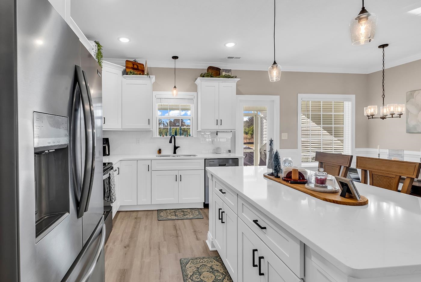 384 William Nobles Road Aynor, SC 29511 - Photo 14 of 38 Kitchen with stainless steel appliances, white cabinets, light wood finished floors, a center island, and pendant lighting